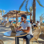 Designer working at a beachside cafe